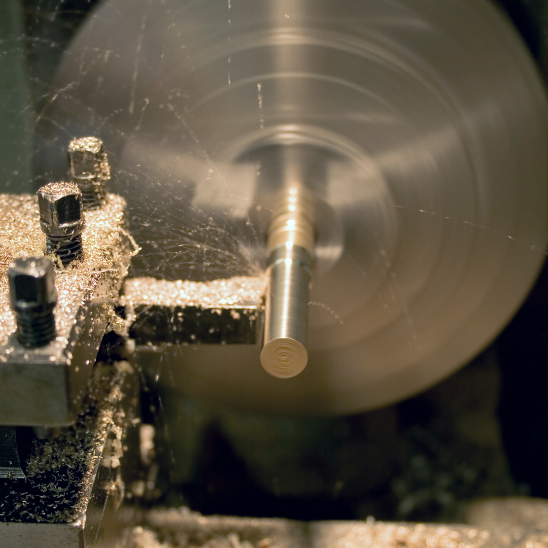 Metal rod being cut by a lathe.