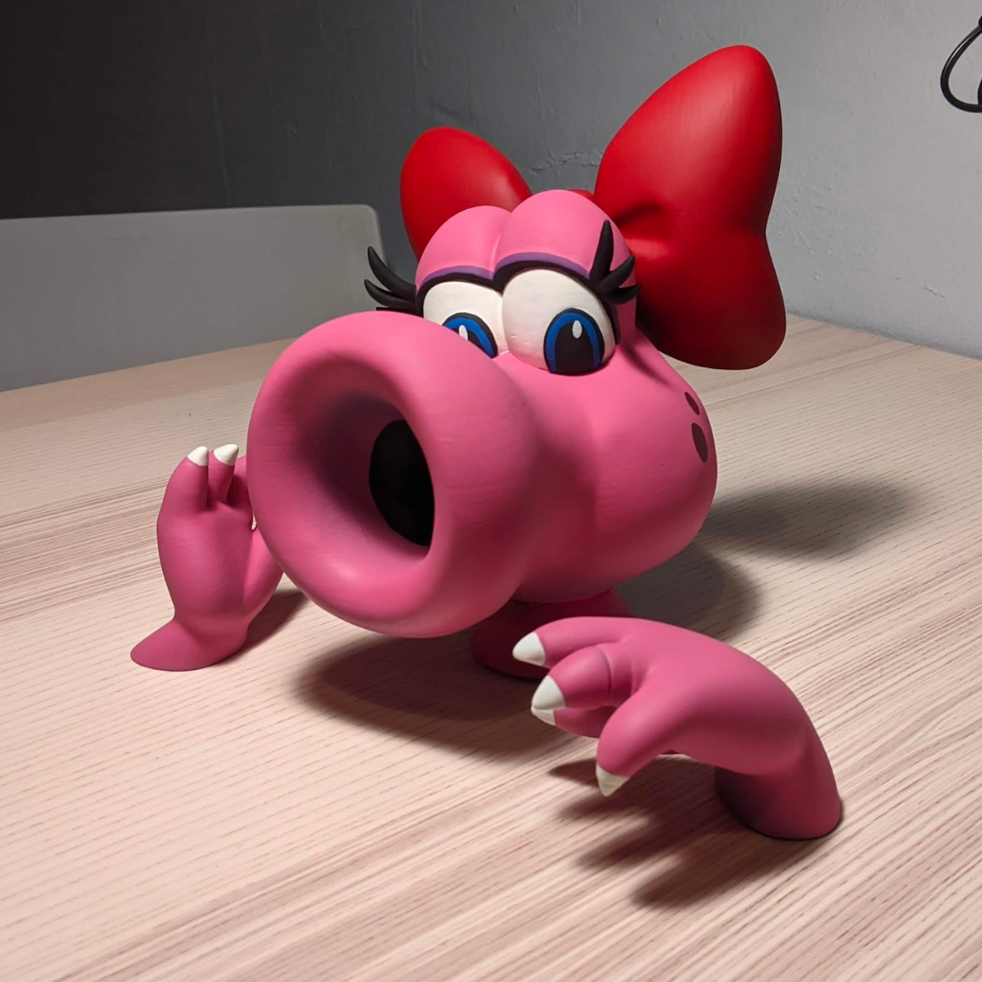 Full color 3D print of Birdo, a.k.a. pink baby Yoshi from Mario Brothers.